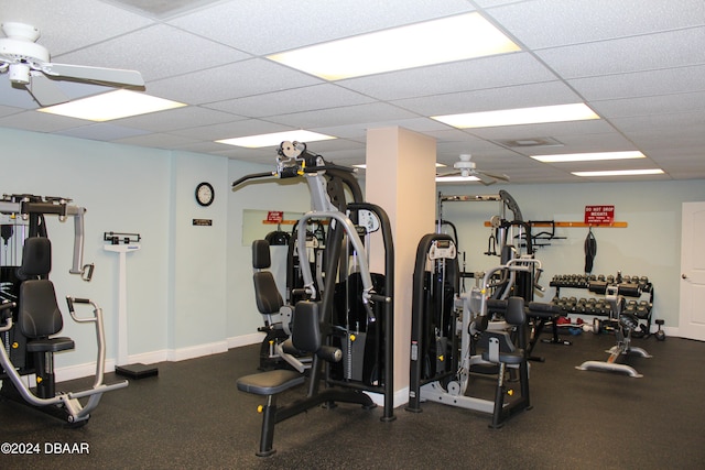 workout area with ceiling fan and a drop ceiling