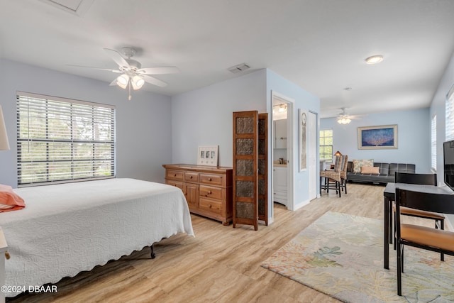 bedroom with multiple windows, ceiling fan, and light wood-type flooring