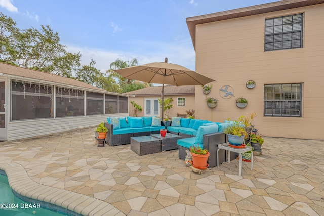 view of patio with an outdoor hangout area and a sunroom