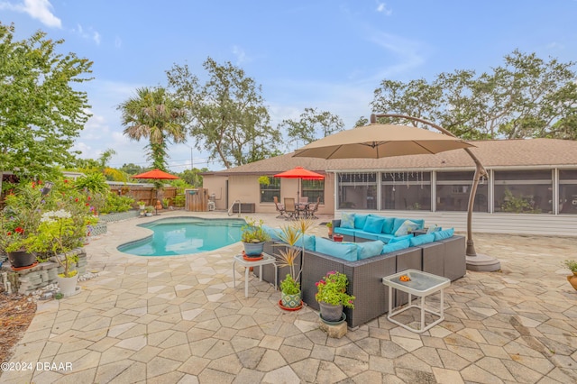 view of pool featuring an outdoor living space, a sunroom, and a patio area