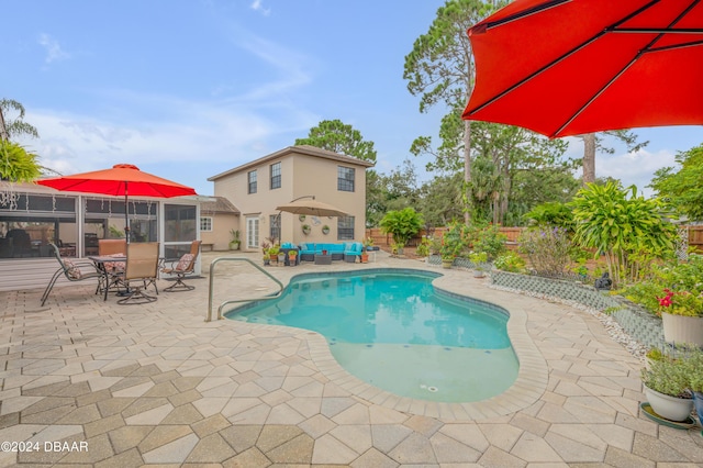 view of swimming pool with an outdoor living space and a patio