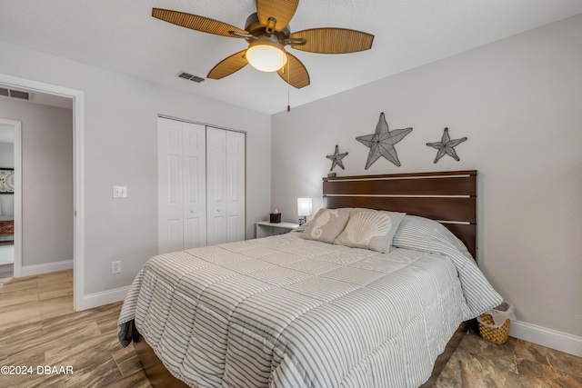 bedroom featuring hardwood / wood-style flooring, a closet, and ceiling fan