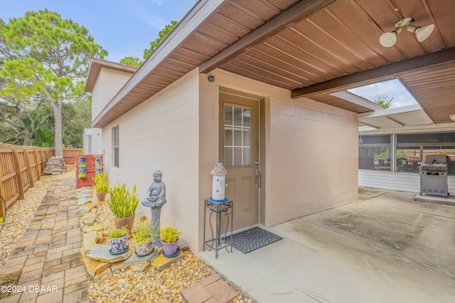 exterior space with a sunroom, a patio, and ceiling fan