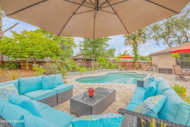 view of pool with an outdoor living space and a patio