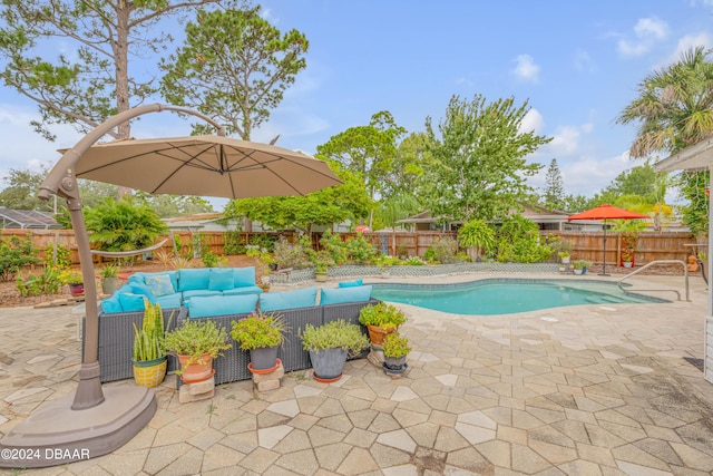 view of swimming pool with outdoor lounge area and a patio