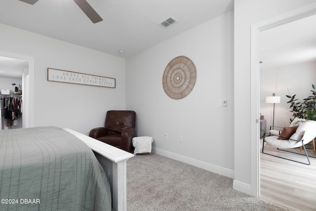 bedroom featuring light carpet and ceiling fan