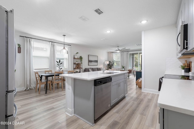 118 Pitching Wedge Dr, Daytona Beach, FL 32124 - kitchen featuring gray cabinets, light countertops, appliances with stainless steel finishes, open floor plan, and ceiling fan