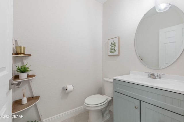 bathroom featuring tile patterned floors, vanity, and toilet