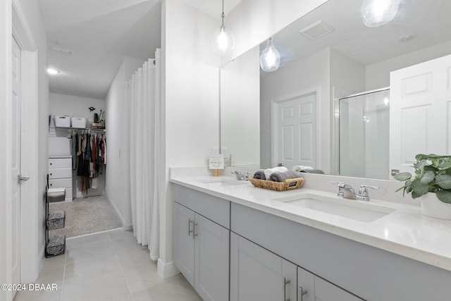 bathroom with vanity, tile patterned floors, and an enclosed shower