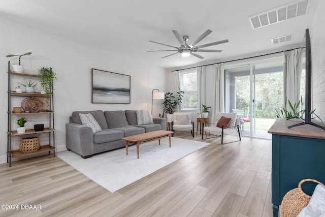 living room with ceiling fan and light wood-type flooring