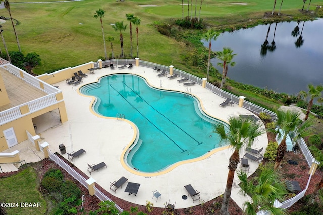 view of swimming pool featuring a patio area and a water view