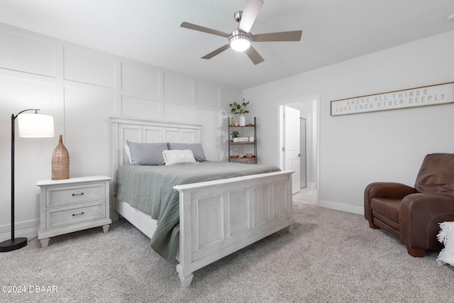 carpeted bedroom with ceiling fan and ensuite bath