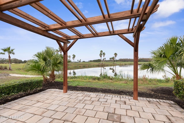 view of patio / terrace featuring a pergola and a water view