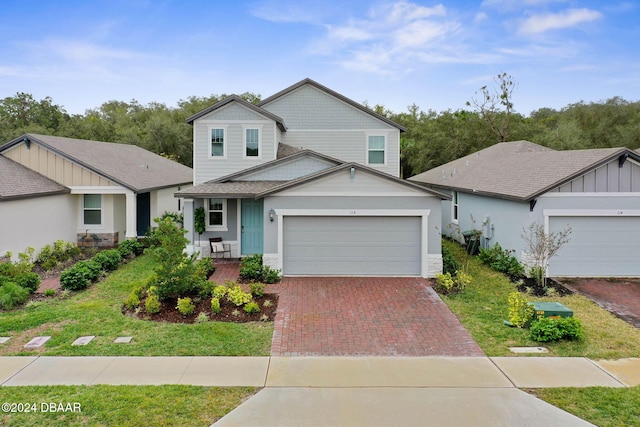 view of front of house featuring a garage and a front lawn