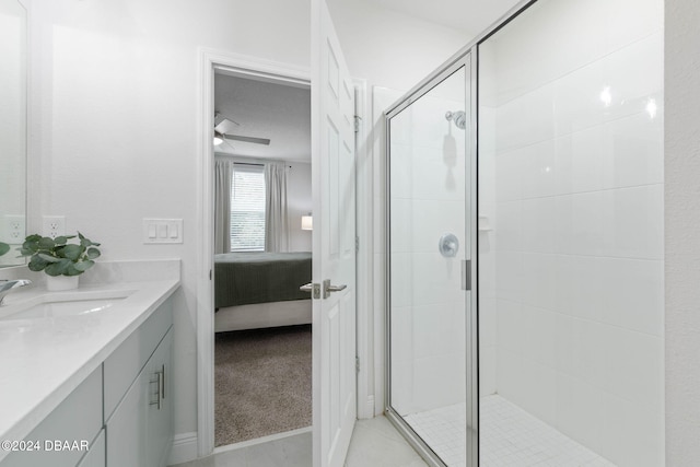 bathroom with ceiling fan, vanity, and an enclosed shower