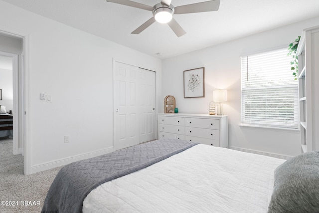 carpeted bedroom featuring a closet and ceiling fan