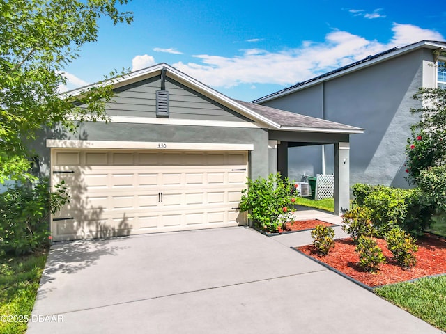 330 Charles Dr, Deland, FL 32724 - view of front of property with an attached garage, stucco siding, and driveway