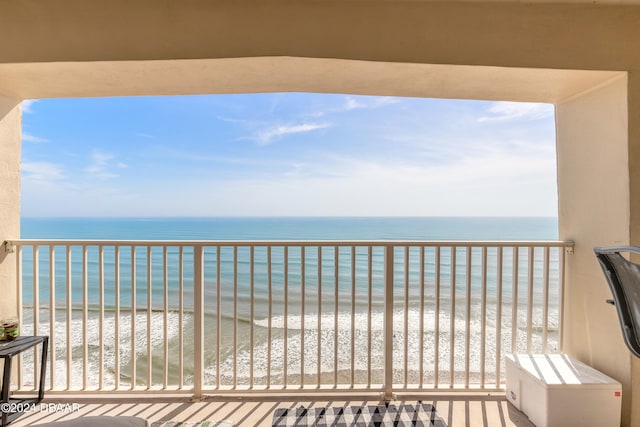 balcony with a beach view and a water view