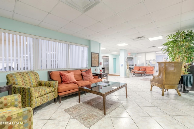 tiled living room featuring a paneled ceiling