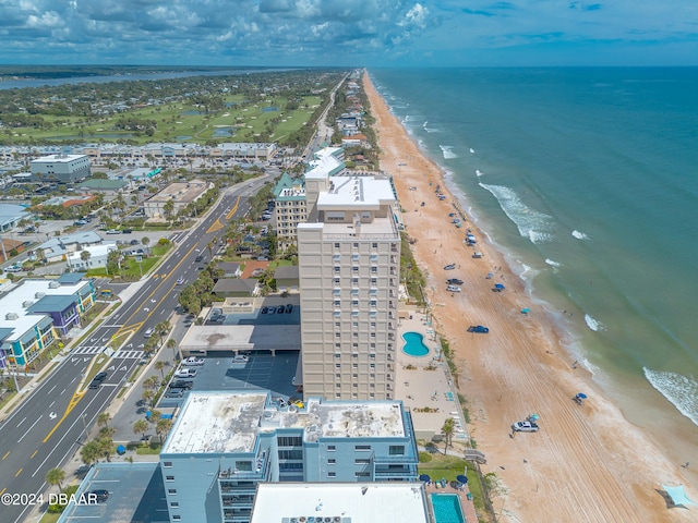 bird's eye view featuring a water view and a beach view