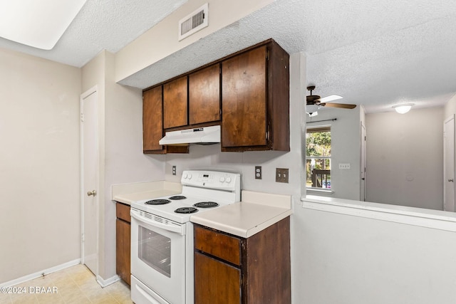 kitchen featuring white electric range oven, ceiling fan, and a textured ceiling