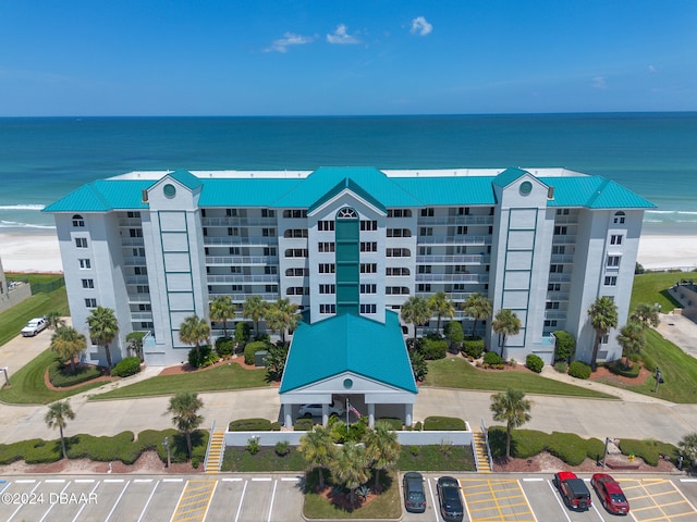 view of property featuring a beach view and a water view