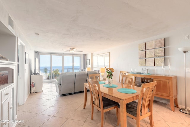 4641 S Atlantic Ave Unit 3060, Ponce Inlet, FL 32127 - dining space with light tile patterned floors, a ceiling fan, and floor to ceiling windows
