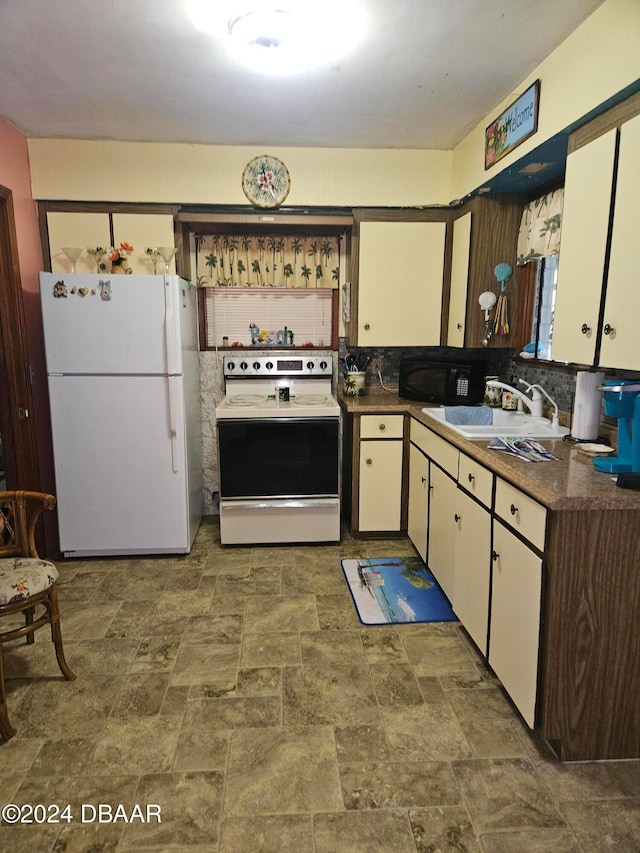 kitchen featuring white cabinets, white appliances, tasteful backsplash, and sink