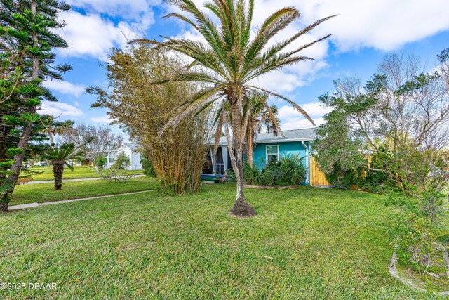 ranch-style house featuring a garage and a front lawn