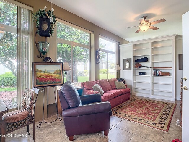 living room featuring light tile patterned floors and ceiling fan