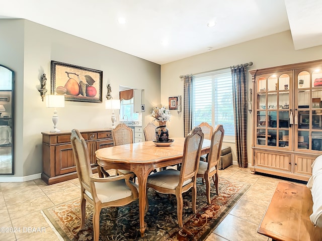 dining space featuring light tile patterned floors