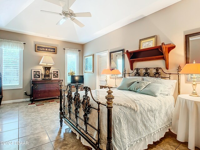 bedroom with ceiling fan and tile patterned floors