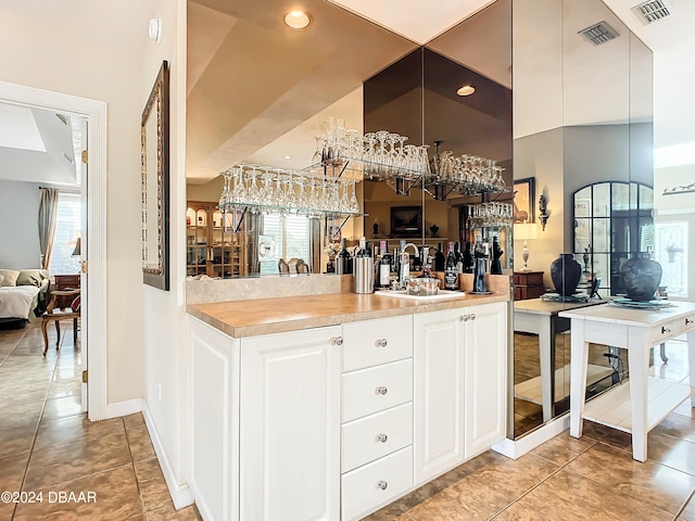 kitchen featuring white cabinetry, a wealth of natural light, and sink