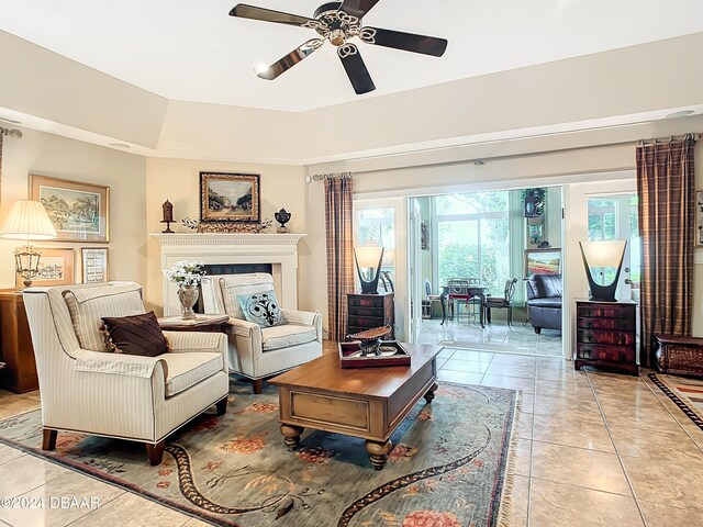 tiled living room featuring ceiling fan