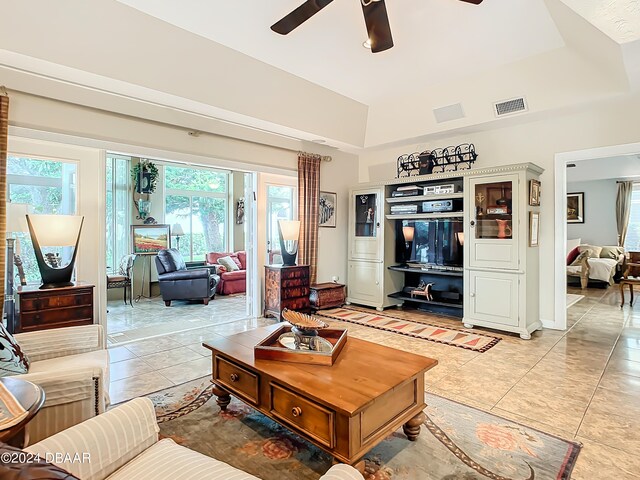 living room with ceiling fan and light tile patterned flooring