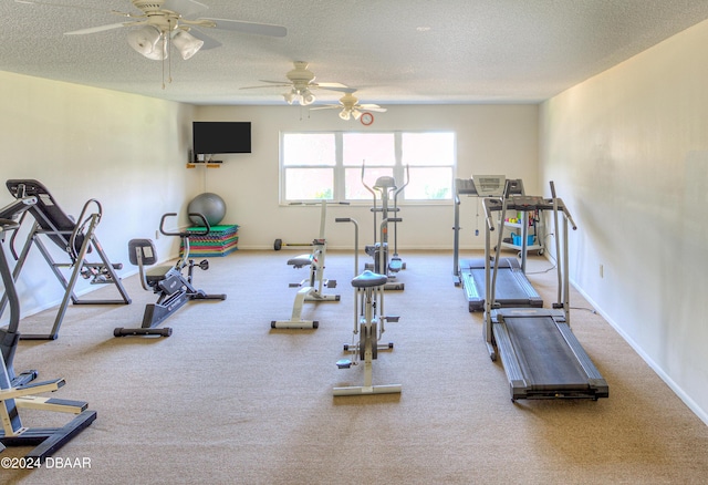 workout room with ceiling fan, carpet floors, and a textured ceiling