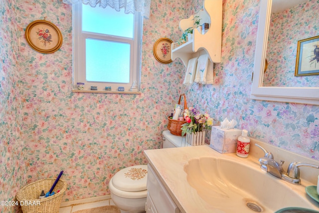 bathroom featuring tile patterned flooring, vanity, and toilet