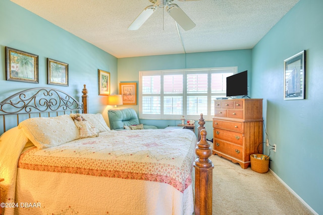 bedroom with carpet, ceiling fan, and a textured ceiling