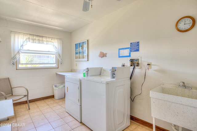 washroom featuring washer and clothes dryer, ceiling fan, light tile patterned flooring, and sink