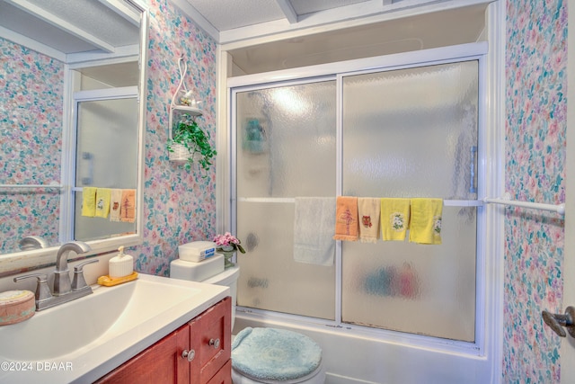 full bathroom with vanity, enclosed tub / shower combo, and toilet