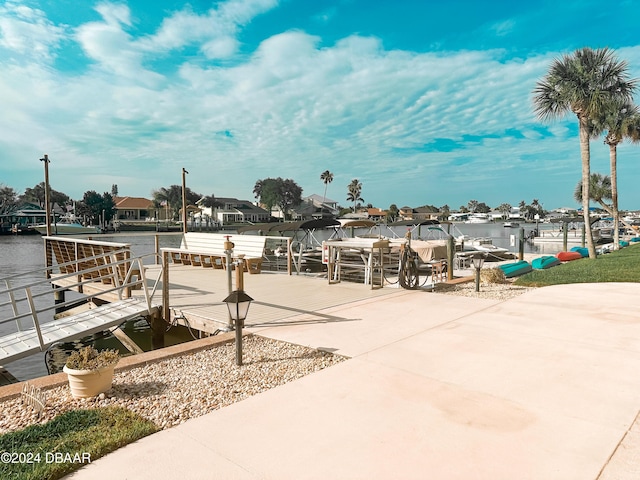 view of property's community featuring a water view and a boat dock