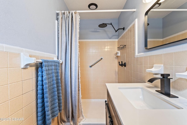 bathroom featuring tile walls, vanity, and a shower with curtain