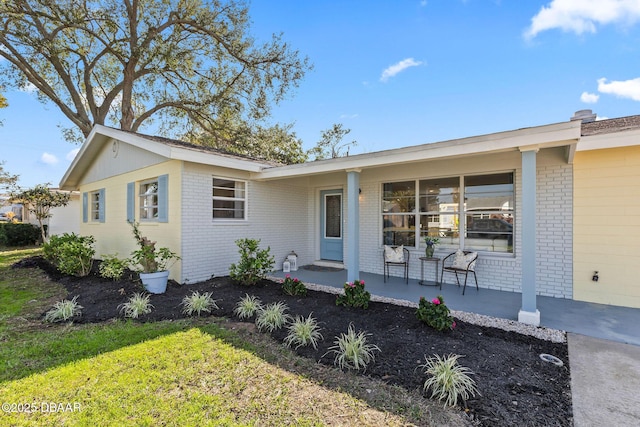 ranch-style home with a porch and a front yard