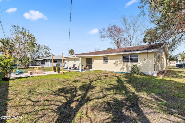 rear view of house with a patio and a yard