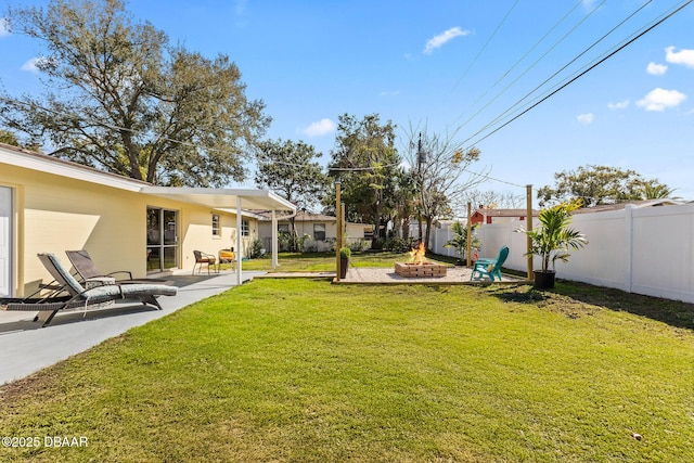 view of yard featuring a patio and a fire pit