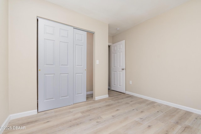 1808 Green Pl, Ormond Beach, FL 32174 - unfurnished bedroom with wood finished floors, baseboards, and a closet