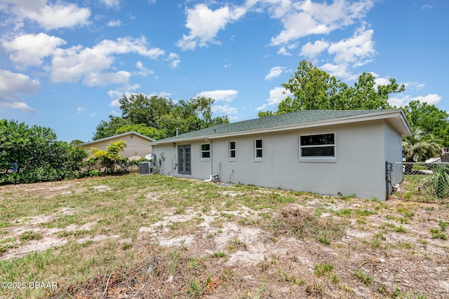 1808 Green Pl, Ormond Beach, FL 32174 - rear view of house with stucco siding, cooling unit, and roof with shingles