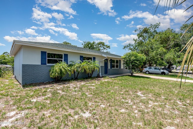 1808 Green Pl, Ormond Beach, FL 32174 - ranch-style home featuring brick siding, stucco siding, and a front yard
