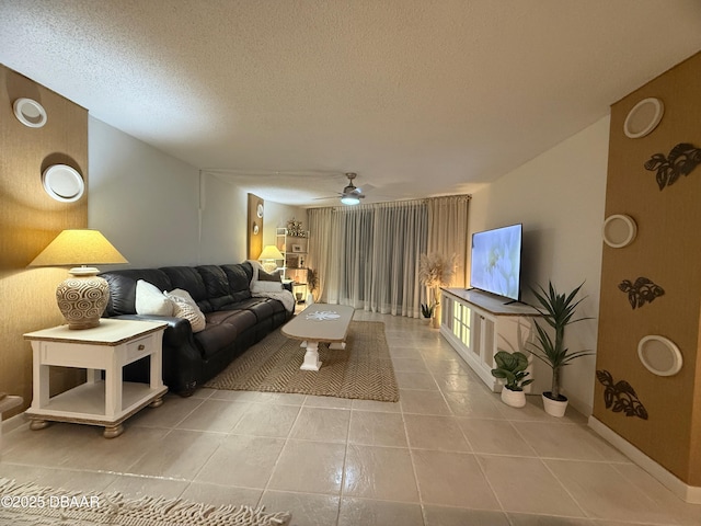 1415 Ocean Shore Blvd Unit 907, Ormond Beach, FL 32176 - tiled living room featuring baseboards, a ceiling fan, and a textured ceiling