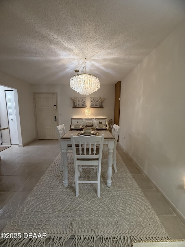 1415 Ocean Shore Blvd Unit 907, Ormond Beach, FL 32176 - unfurnished dining area with baseboards, a textured ceiling, light tile patterned floors, and a notable chandelier
